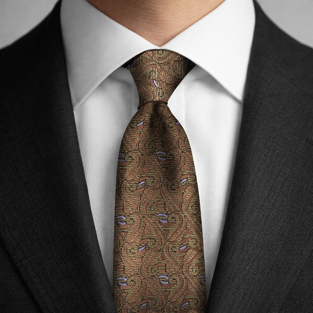 Gold tie worn featuring the Thames Pattern with a charcoal suit