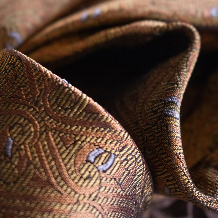 Close-up shot of a gold jacquard silk tie