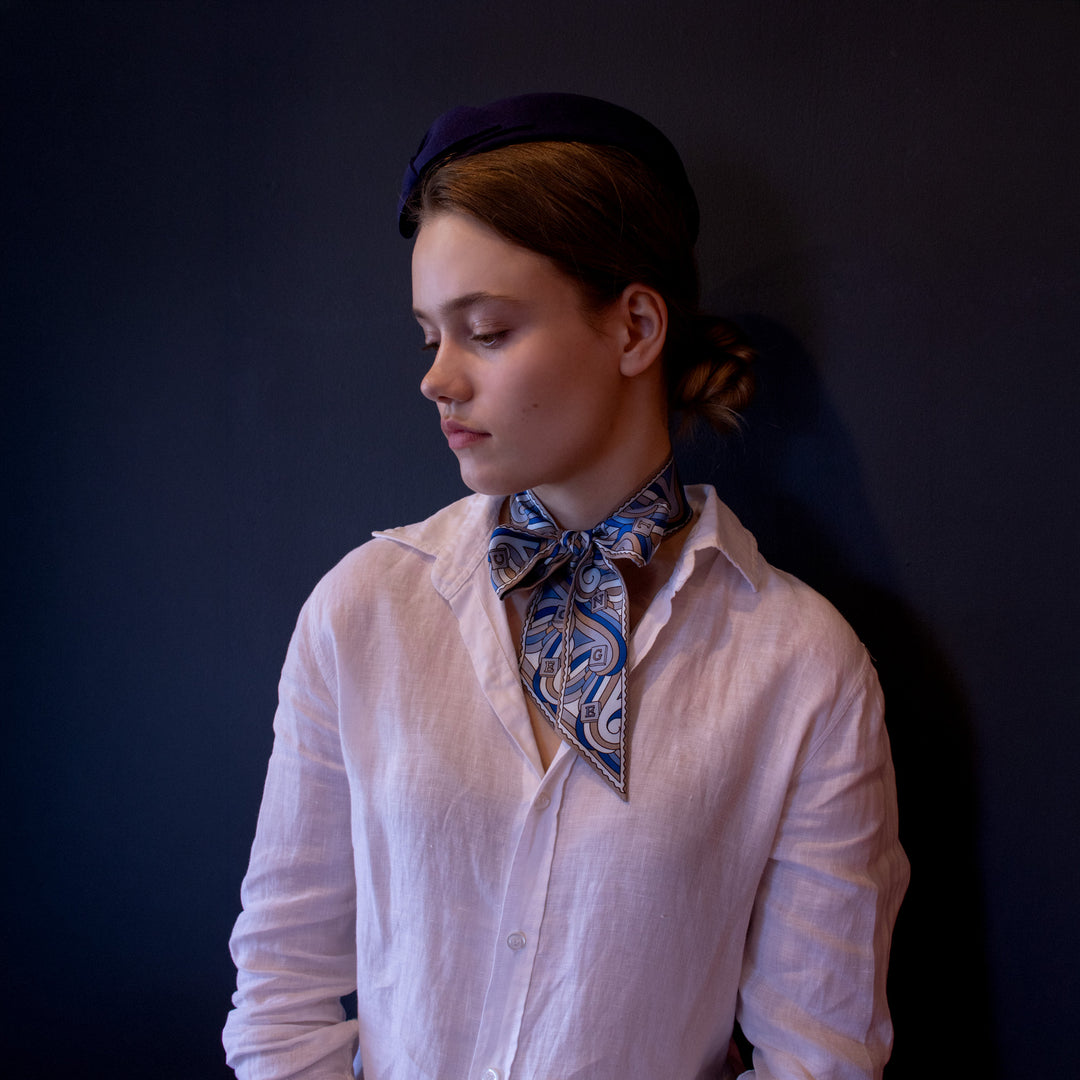 Thames Twilly Ribbon Scarf worn as a bow. Blue silk scarf. Luxury Scarves, made in England | Furious Goose