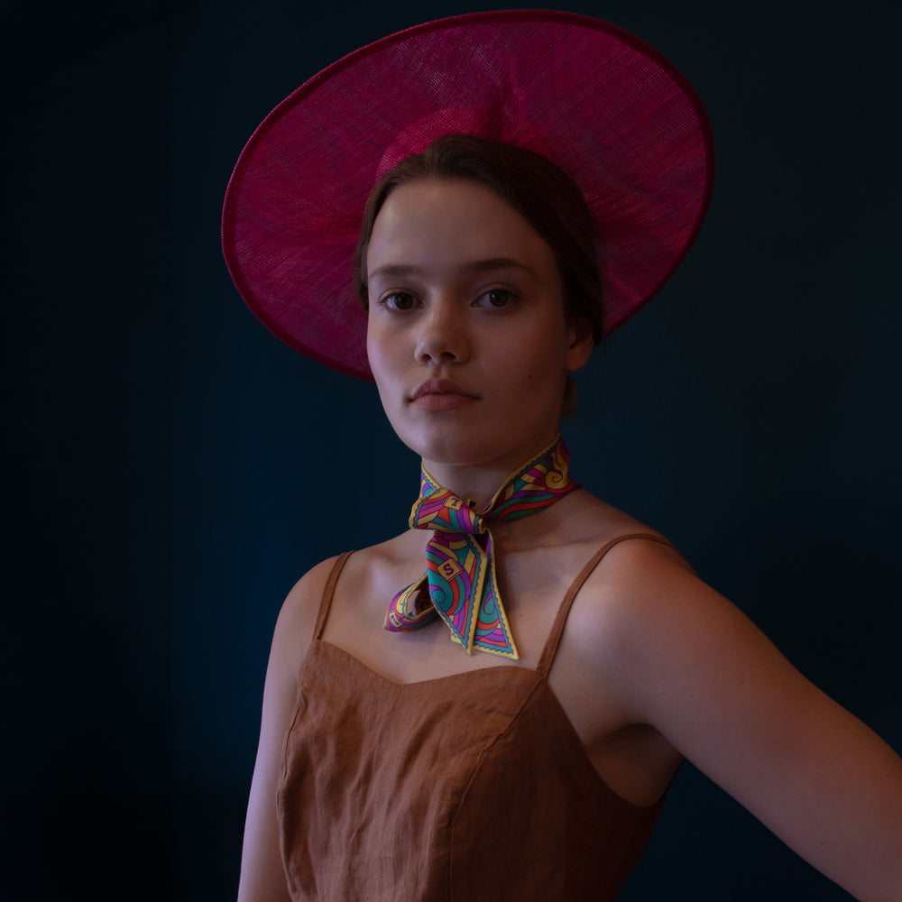 Multicoloured silk twirly scarf worn at the neck for race day look. Made in England | Luxury Ribbon Scarves, London